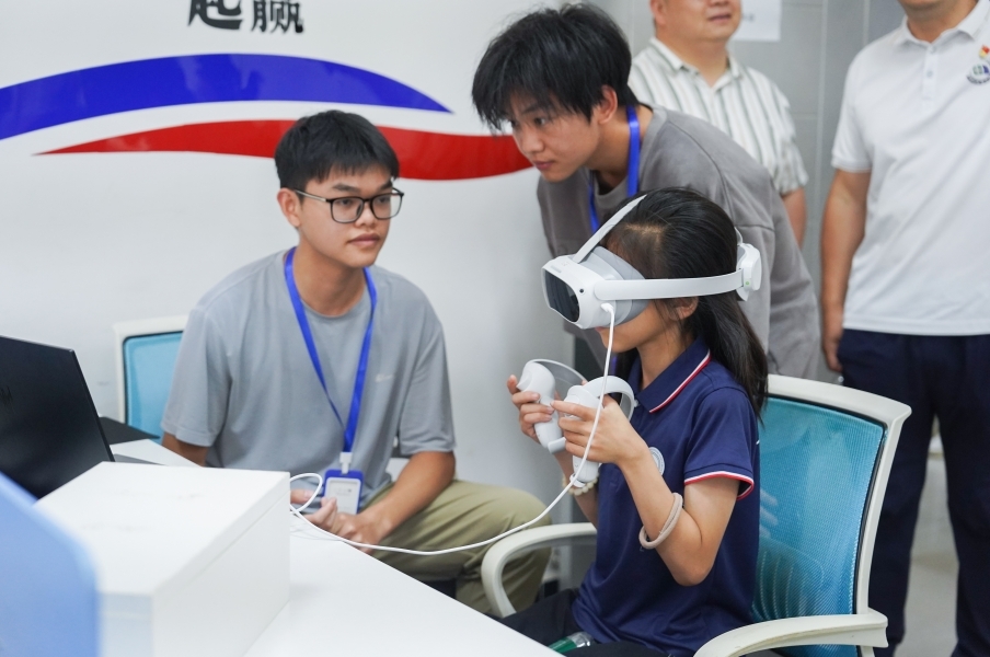 beat365中文官方网站信息工程学院学生正在指导研学团成员体验VR游戏。